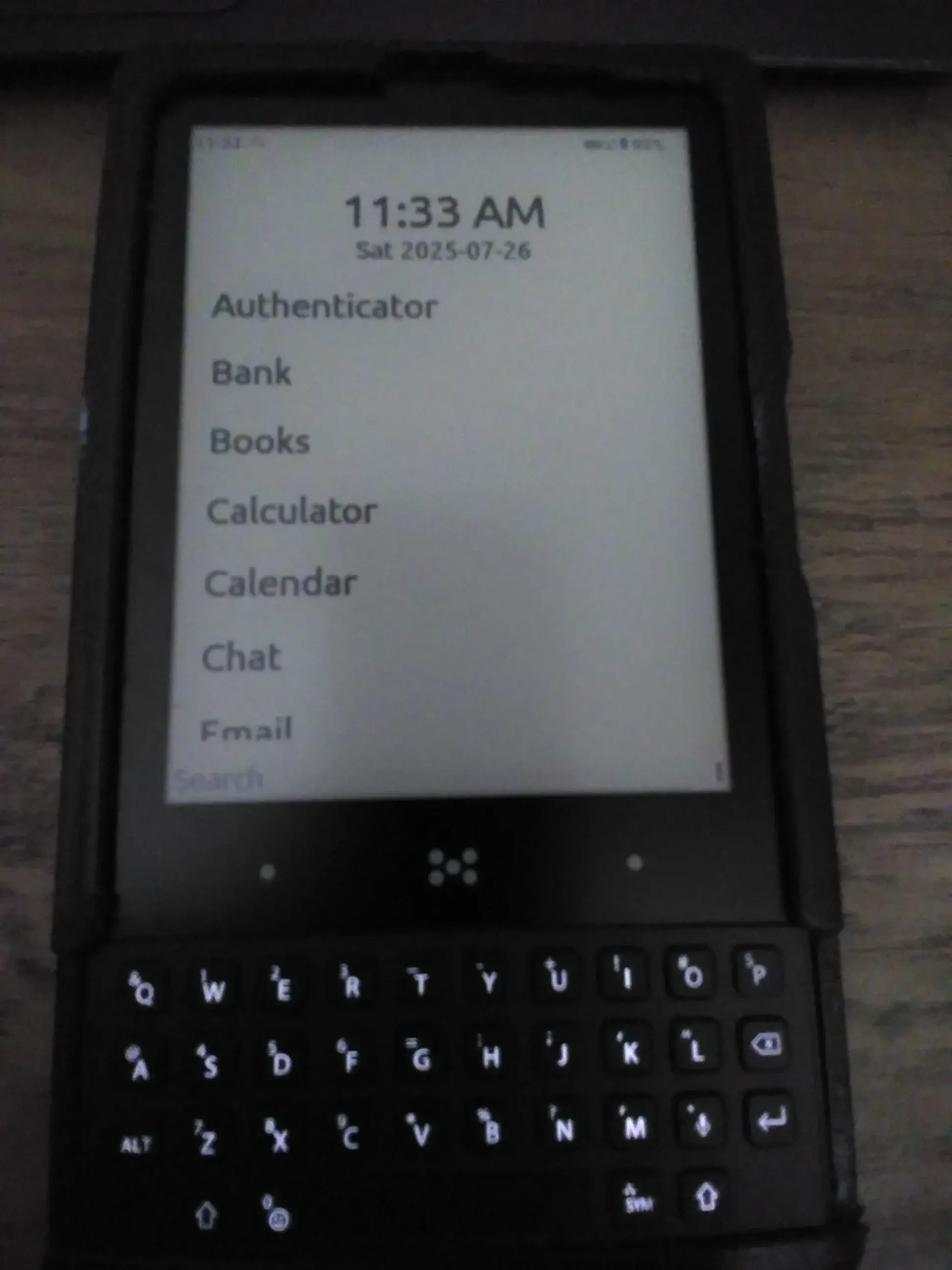 Minimal Phone displaying the home screen and in a slightly crappy 3D printed case.